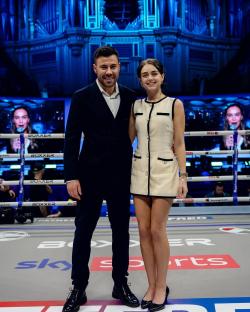 Photo of a man and woman standing in a boxing ring.