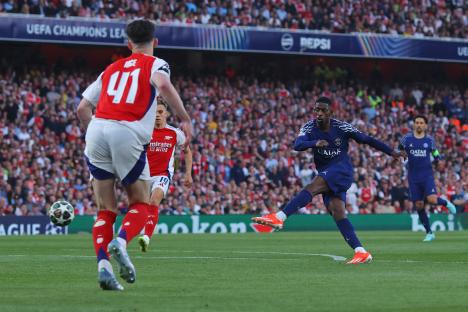 Ousmane Dembele of Paris Saint-Germain scoring a goal during a Champions League match.