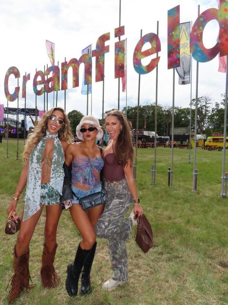 Three women posing at Creamfield festival.