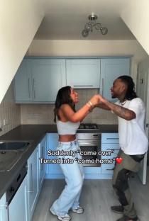 Couple dancing in a kitchen.