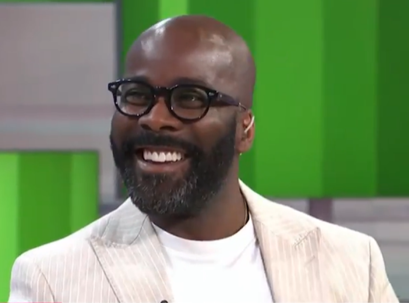 Smiling man with glasses and beard.