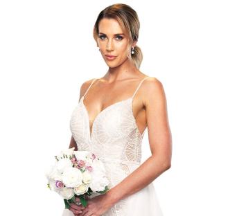 Rebecca Zemek in a wedding dress holding a bouquet.