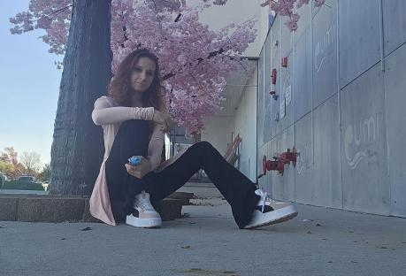 Woman sitting under a flowering tree.