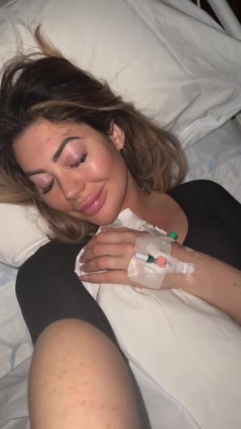 Woman in hospital bed with IV.