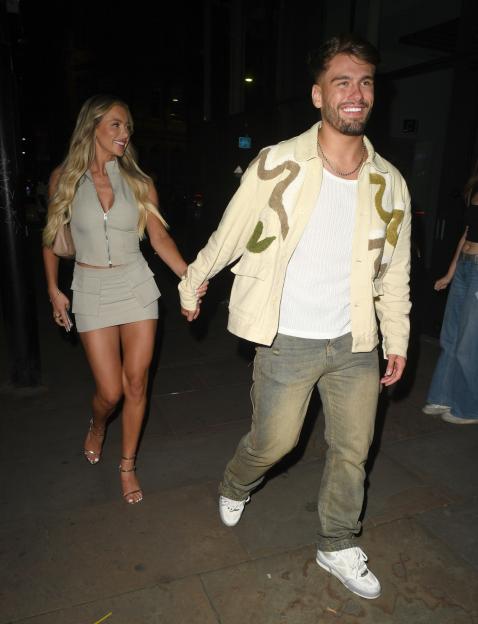 Jacques O'Neill and Ellie O'Donnell holding hands leaving a restaurant.
