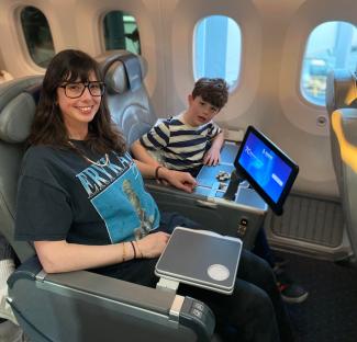 Woman and child seated in airplane seats.