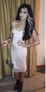 Woman in white dress with black and white hair.