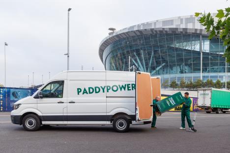 Paddy Power van unloading a trophy cabinet outside a stadium.