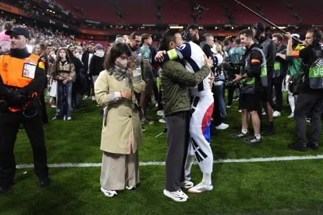 Son Heung-Min celebrating with his family after a soccer victory.
