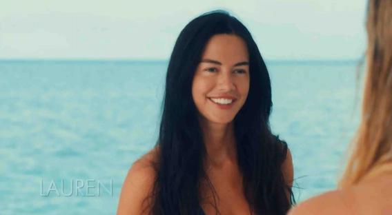 Woman smiling by the ocean.