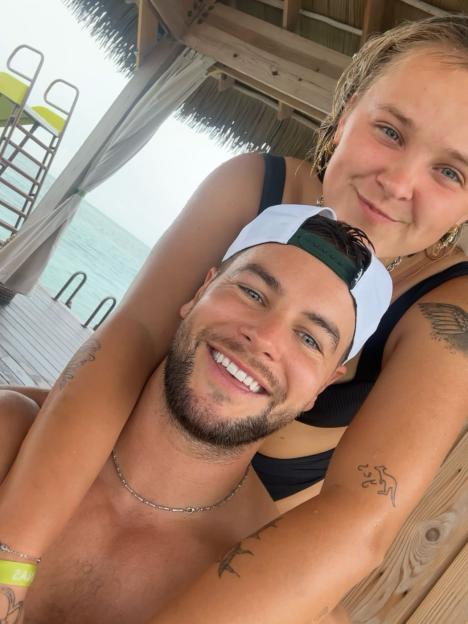 Jojo Siwa and Chris in a close embrace.