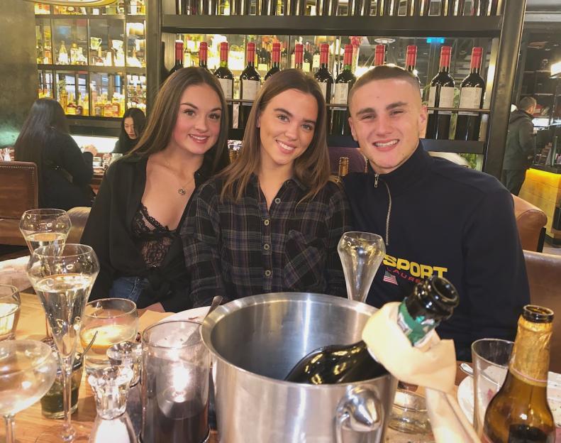Leah Keane with two people at a table in a restaurant.