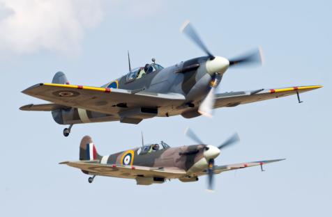 Two Supermarine Spitfire fighter planes in flight.