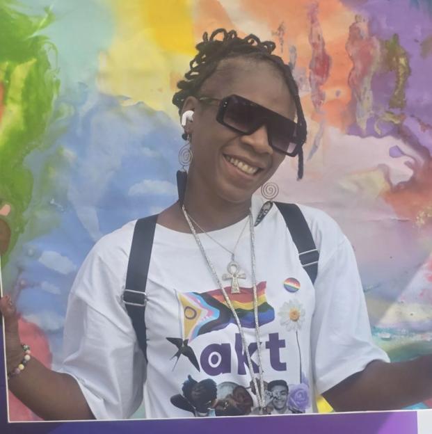 Lei Bartley smiling in a Bloomberg frame with a colorful background.