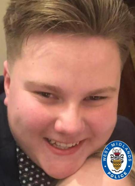 Ben Corfield, one of two teenagers who died after being hit by a car, is shown with a broad smile and wearing a patterned shirt and dark jacket.