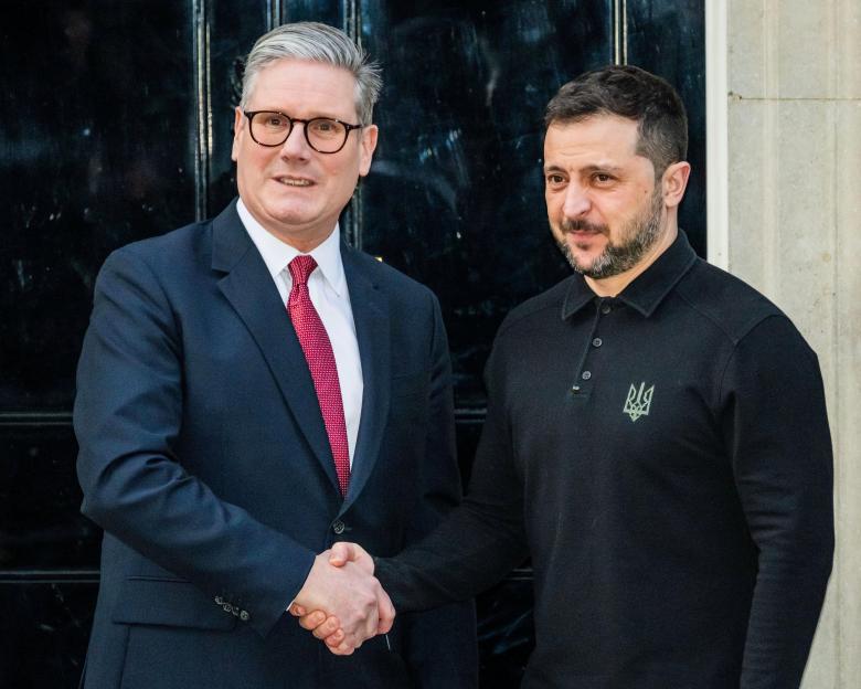 Sir Keir Starmer and President Volodymyr Zelenskyy shaking hands.