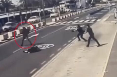 Police officers shooting a man wielding a knife at an airport.