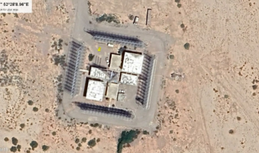 Aerial view of a complex of buildings in a desert environment.