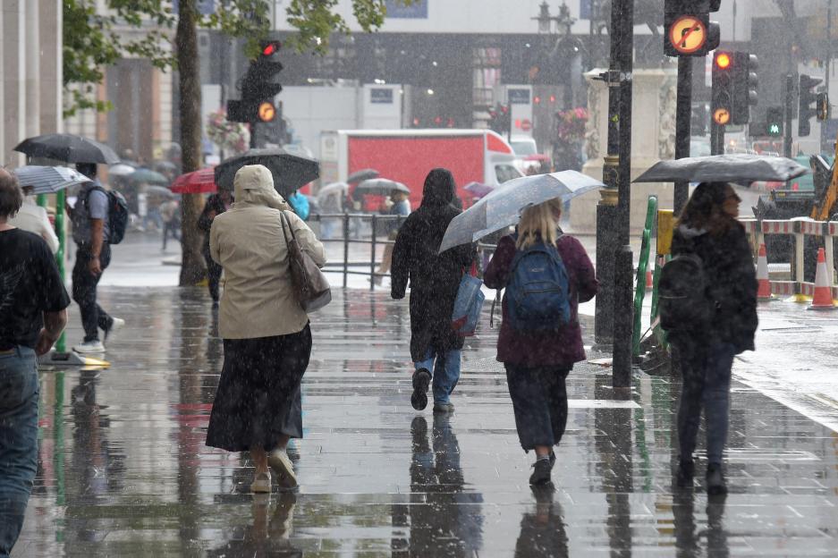 People walking in heavy rain in London.