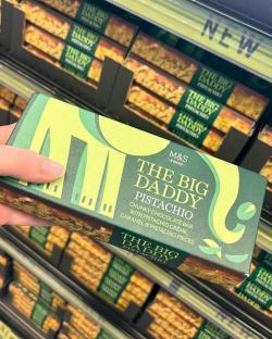 Hand holding a box of M&S The Big Daddy Pistachio chunky chocolate bar.