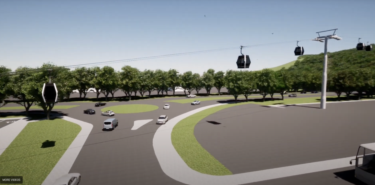 Aerial view of cable cars over a roadway.