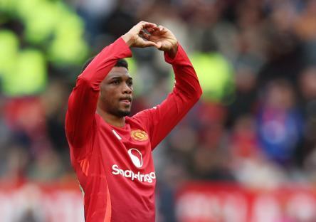 Manchester United's Amad Diallo making a heart shape with his hands.