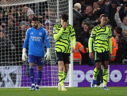 Arsenal players looking dejected after a soccer game.