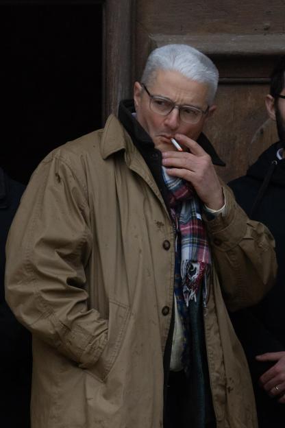 Philippe Vedovini, Emile Soleil's grandfather, smoking a cigarette at his grandson's funeral.