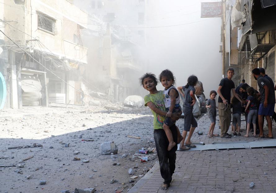 Palestinian children in Gaza City at the site of Israeli strikes on a house.