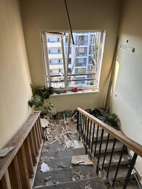 Bomb damage to a Kyiv apartment building staircase and window.