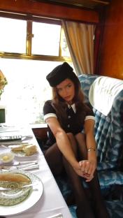 Maura Higgins wearing a black dress and hat.