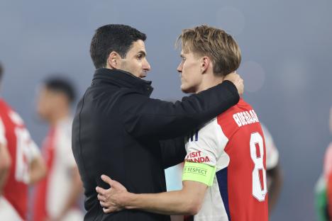 Mikel Arteta consoling Martin Odegaard after a soccer match.