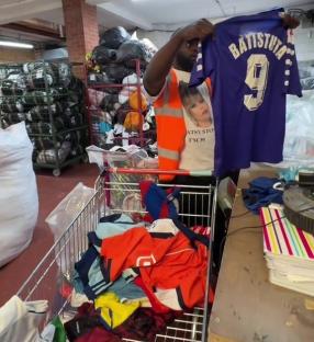 Man holding up a Batistuta #9 soccer jersey found at a charity shop.