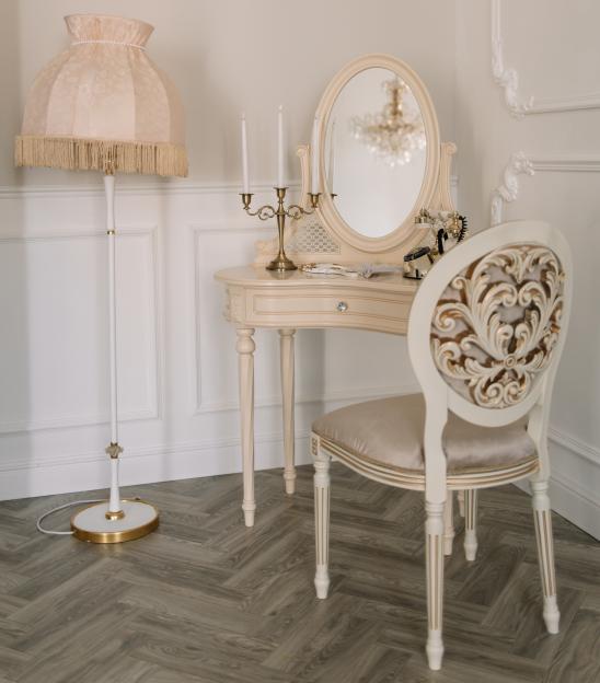 Vintage vanity set with chair and floor lamp.