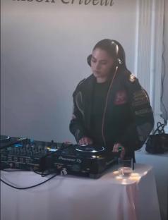 Woman DJing with headphones on.