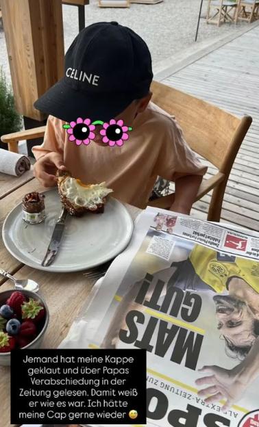Child eating breakfast with newspaper featuring Mats Hummels.