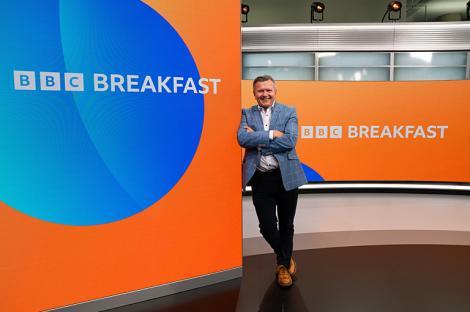 Richard Frediani, BBC Breakfast editor, standing in the BBC Breakfast studio.
