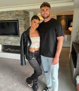 Couple posing in a modern home.