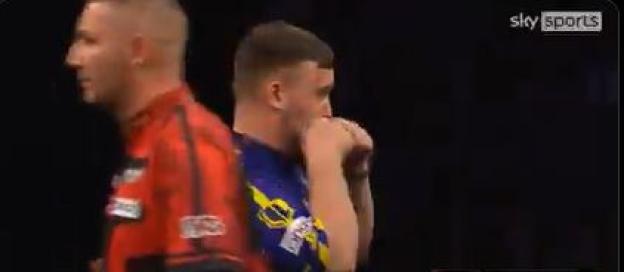Two darts players during a match.