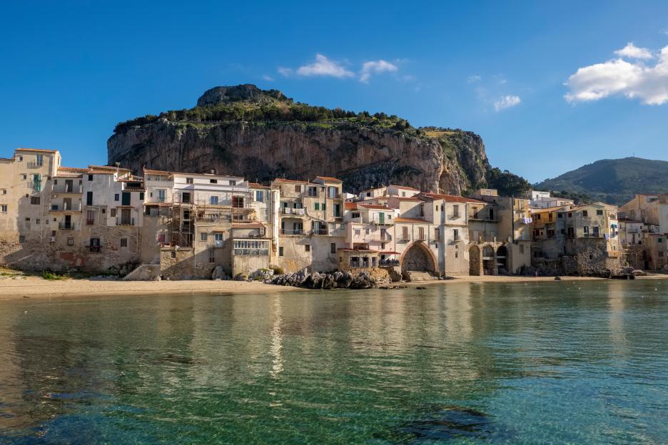 Medieval fishermen's houses on a beach in Cefalu, Sicily.