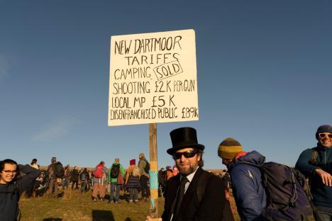 Protestor holding sign detailing Dartmoor tariffs.