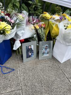 Floral tributes and photos of Kaine and Kailem at the scene of a fatal crash.