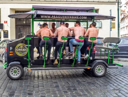 Shirtless men on a beer bike in Prague.