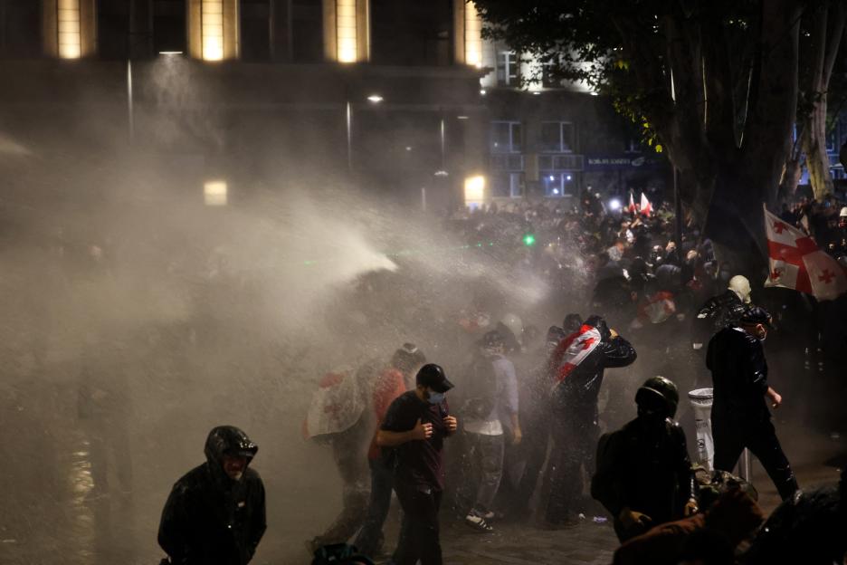 Police use water cannons to disperse protesters during an opposition rally.