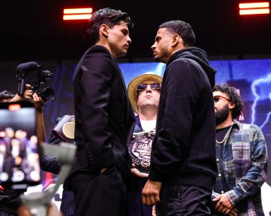 Ryan Garcia (white trunks) punches Devin Haney during a WBC Super Lightweight title boxing match.