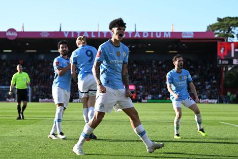Manchester City player celebrating a goal.