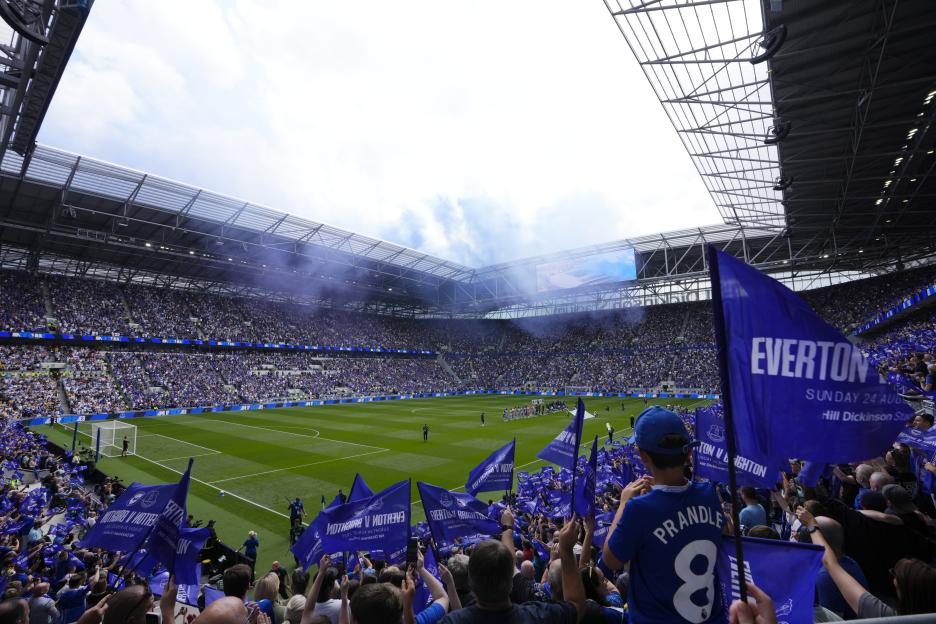 A full stadium at a soccer game kickoff.