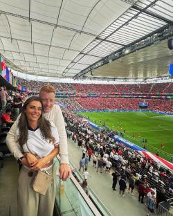 Couple at a soccer match in a stadium.