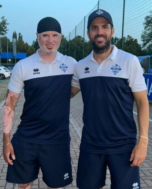 Two men in matching team jerseys.