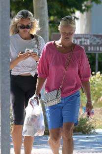Nicoline Artursson and another woman walking down a sidewalk.